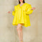 model wearing yellow dress with flowy skirt, oversized sleeves and collar and large yellow bow on the front