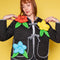 model wearing model wearing black quilted jacket with black and white stripe trim, and 3D red, yellow and blue flower print