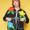 model wearing black quilted jacket with black and white stripe trim, and 3D red, yellow and blue flower print