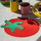 tomato shaped placemat on a table