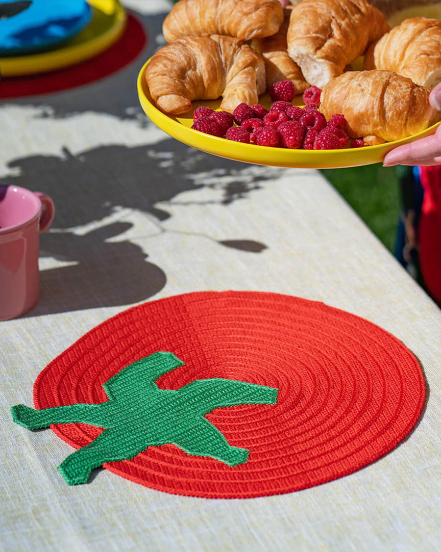 tomato shaped placemat on a table