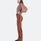 sideview of model wearing brown crushed velvet flared pants