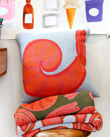 up close of blue throw pillow with colorful shrimp print