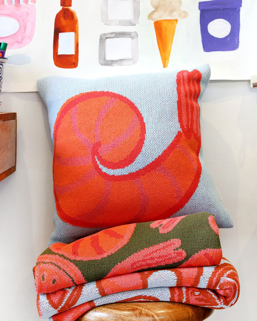 up close of blue throw pillow with colorful shrimp print