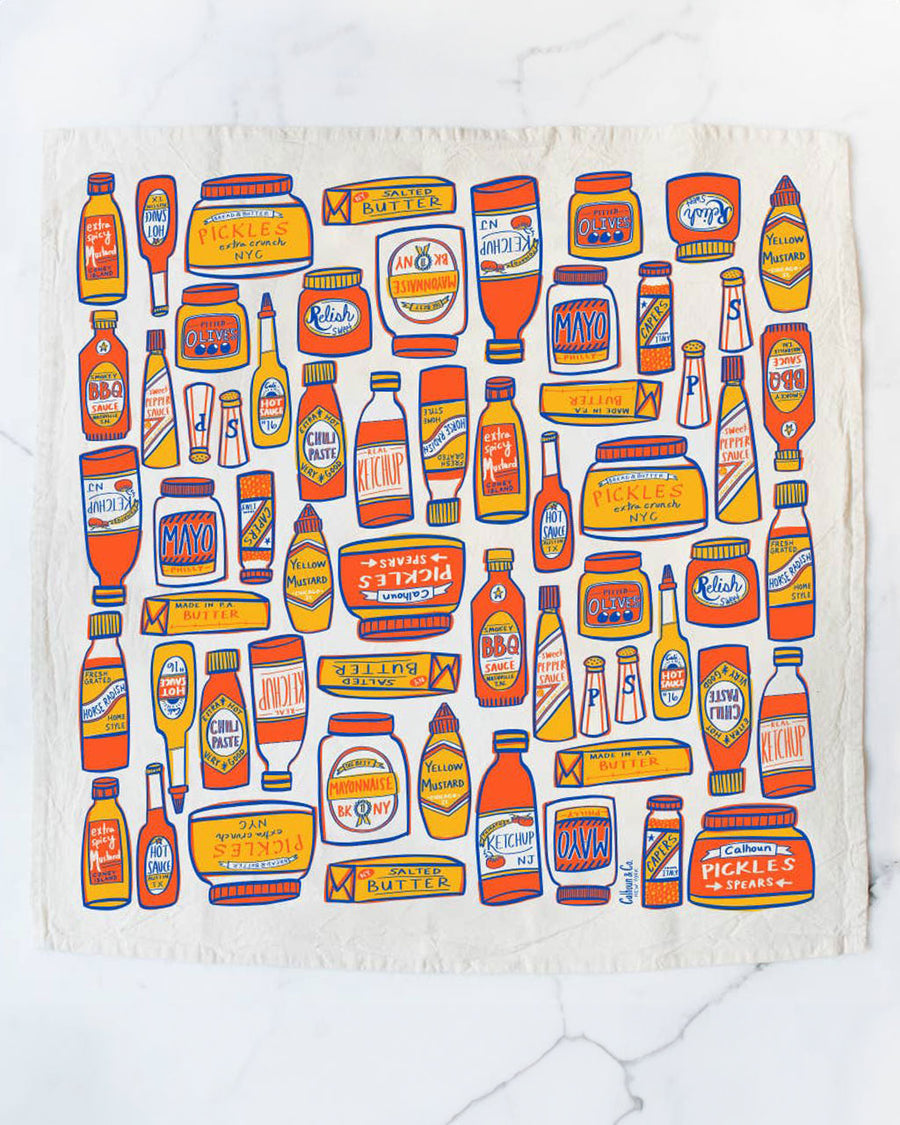 tea towel with different condiment bottles