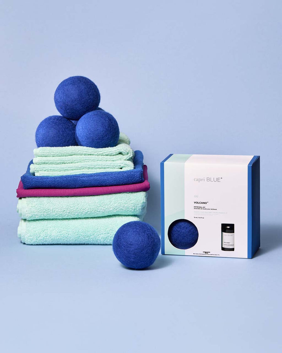 set of three blue dryer balls on a pile of towels