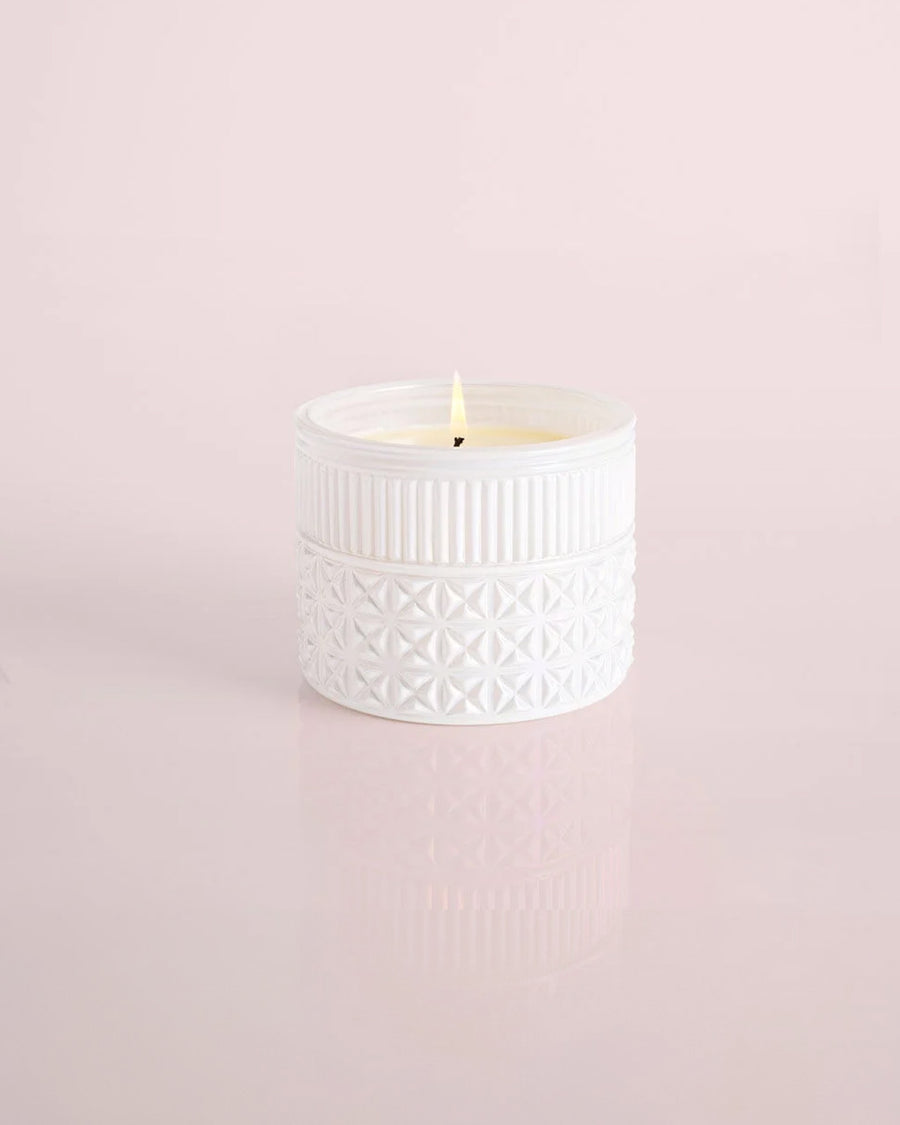 lit white textured opal candle with matching lid