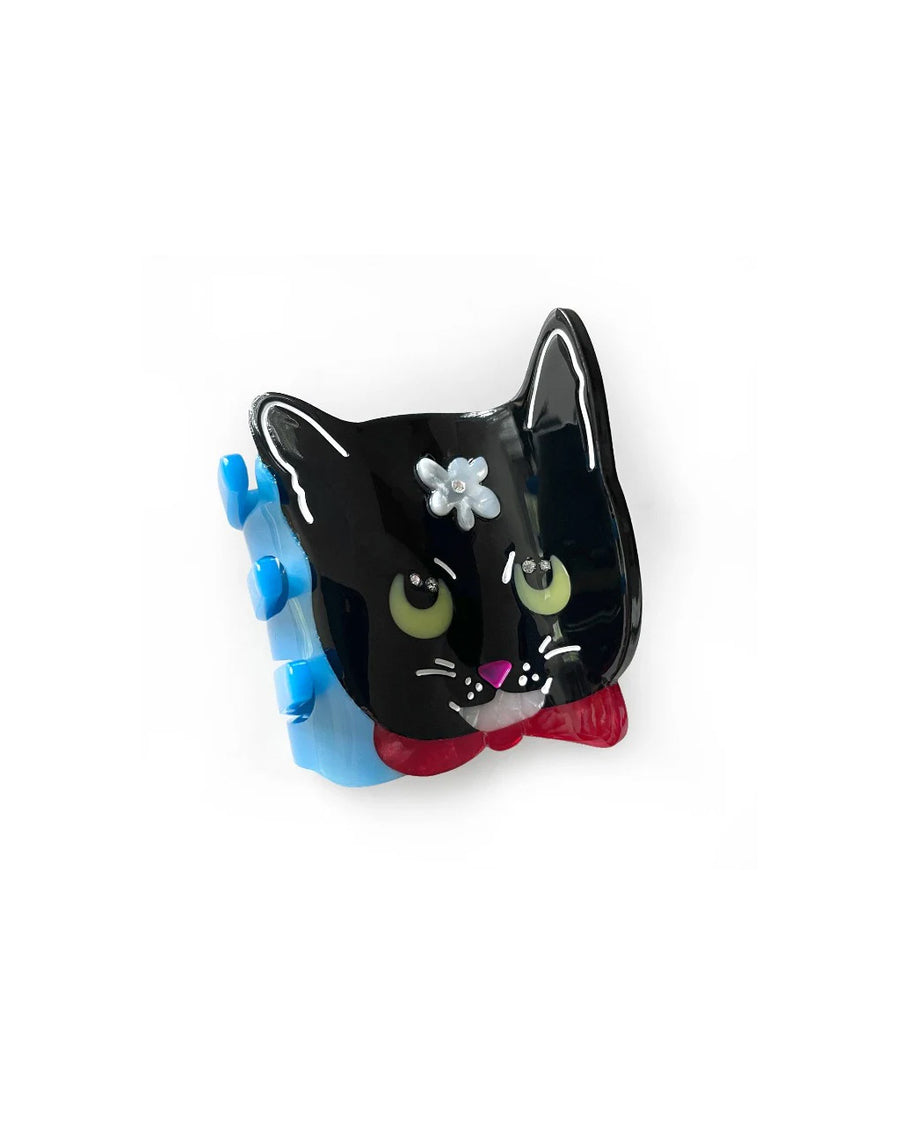 front view of black cat shaped hair claw with white floral and rhinestone detail