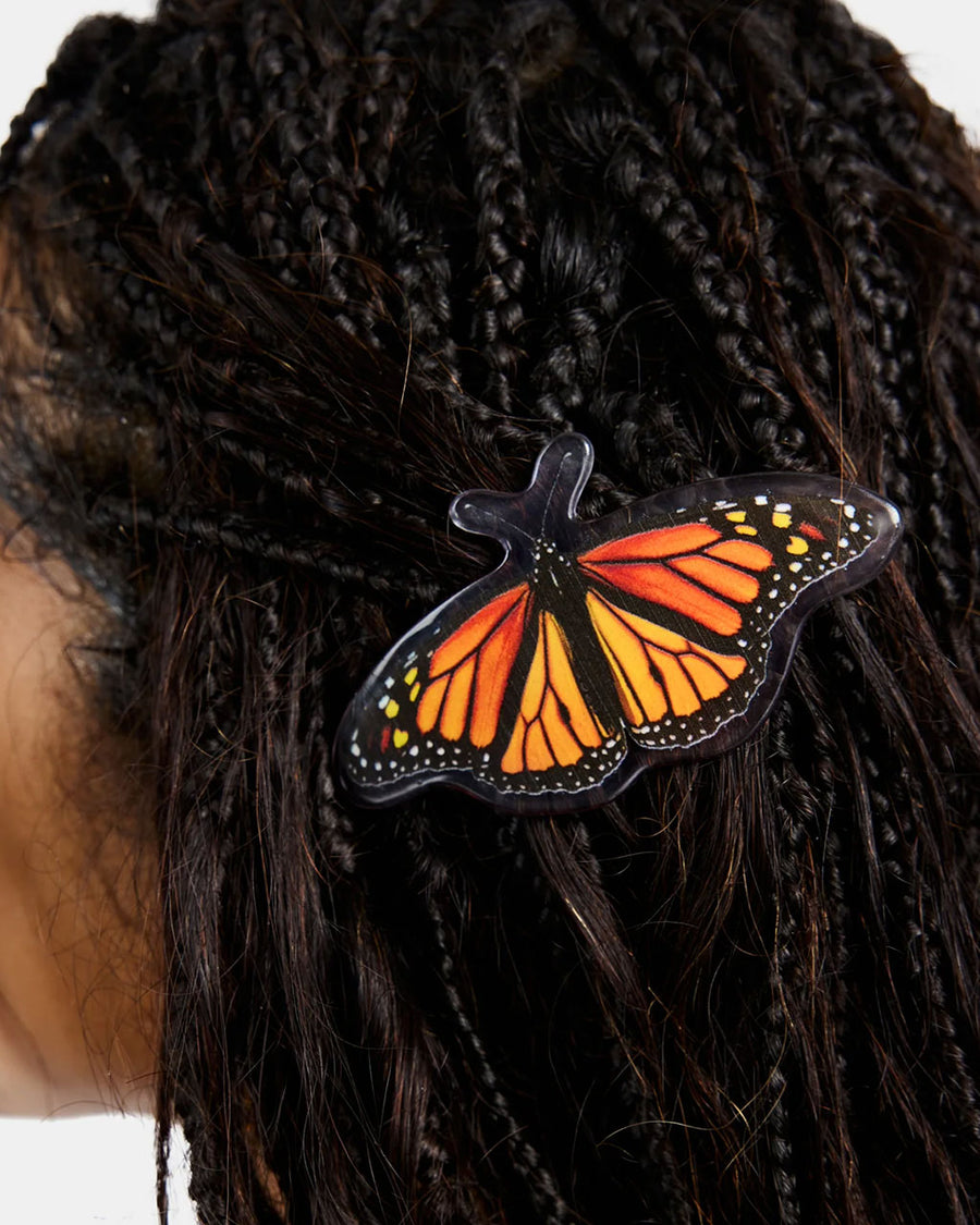 up close of model wearing realistic monarch butterfly hair barrette