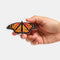 model holding realistic monarch butterfly hair barrette