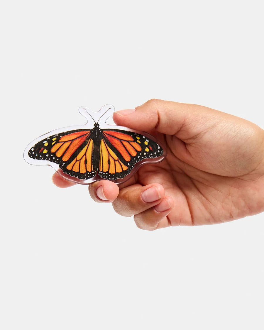 model holding realistic monarch butterfly hair barrette