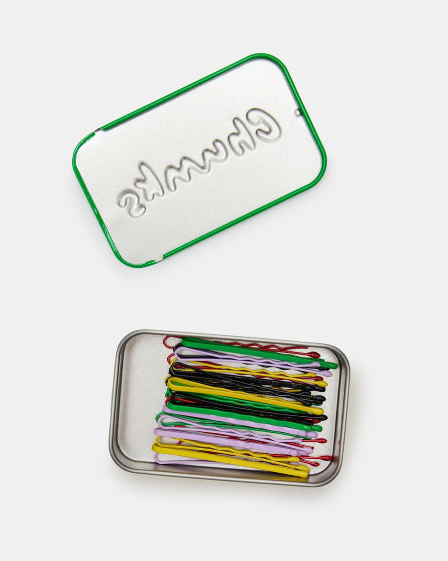 lid off of green tin of colorful bobby pins