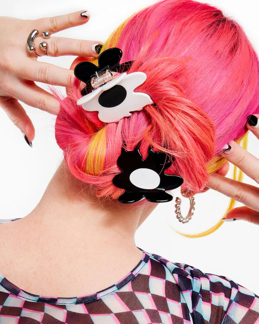 model wearing black and white flower shaped hair claw