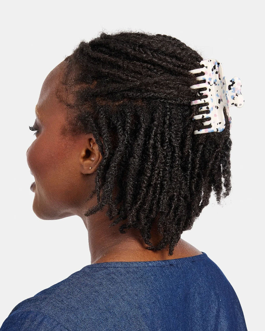 model wearing white small hair claw with blue, pink and black terrazzo print