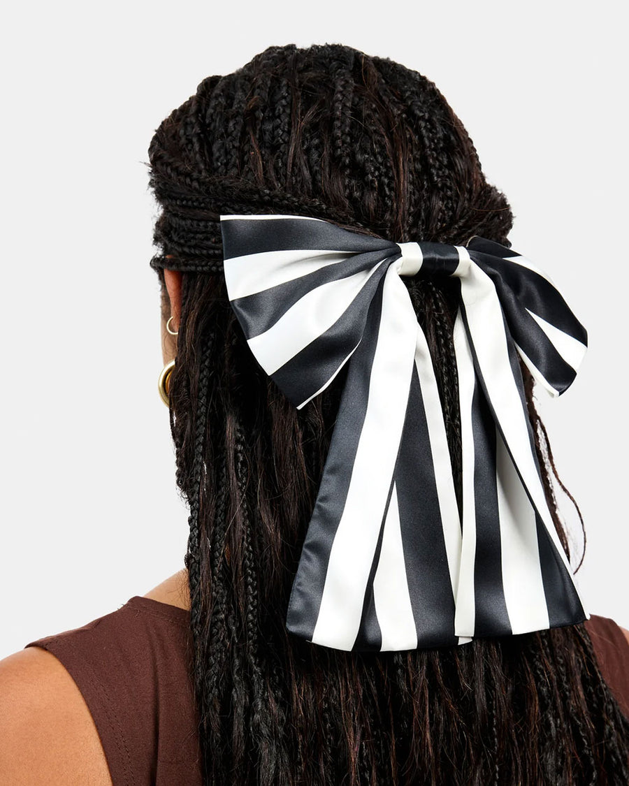 model wearing black and white stripes oversized hair bow clip