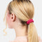 model wearing hot pink skinny scrunchie in their hair