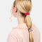 model wearing set of three skinny silk hair scrunchies: grey, hot pink and periwinkle in their hair