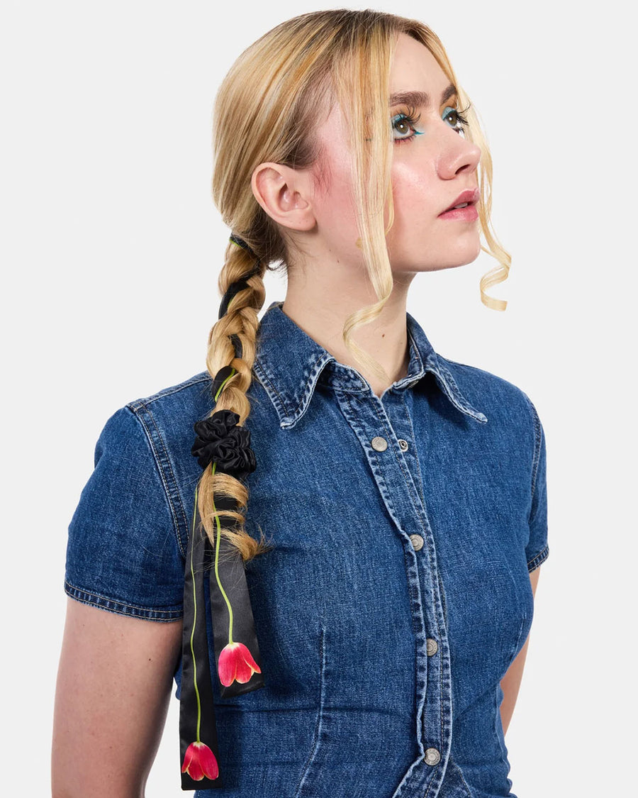 model wearing black pink tulip silk tie with matching black silk scrunchie in their hair