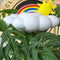 white cloud shaped houseplant waterer with sun and rainbow charm in a potted plant