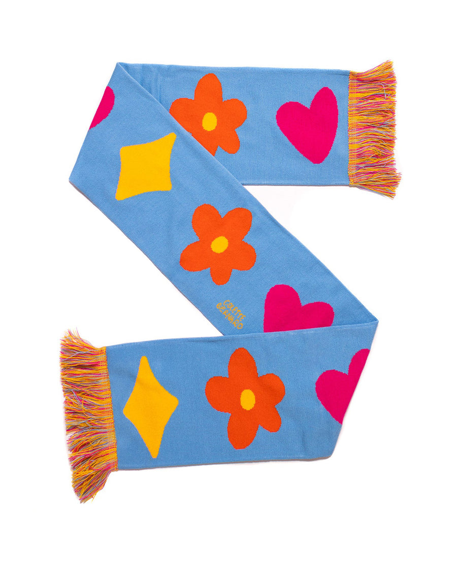 blue rectangle scarf with colorful tassels on the end and yellow diamond, orange flower and pink heart design in a 'z' fold