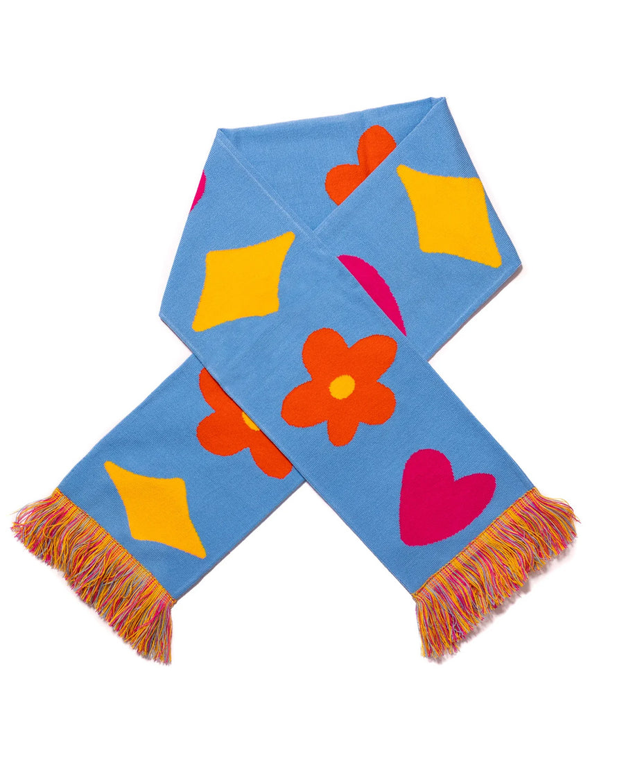 blue rectangle scarf with colorful tassels on the end and yellow diamond, orange flower and pink heart design folded in half