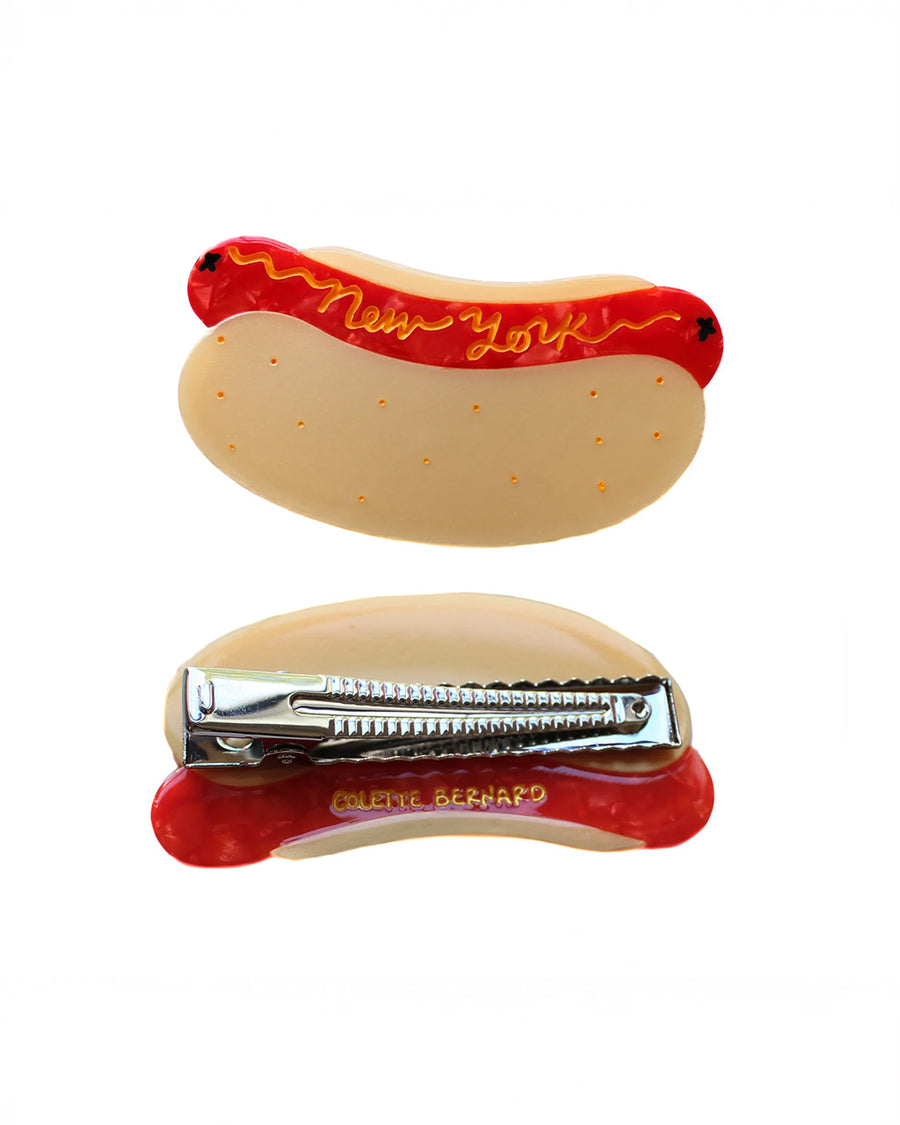 front and back view of hot dog hair clip with 'new york' written in mustard