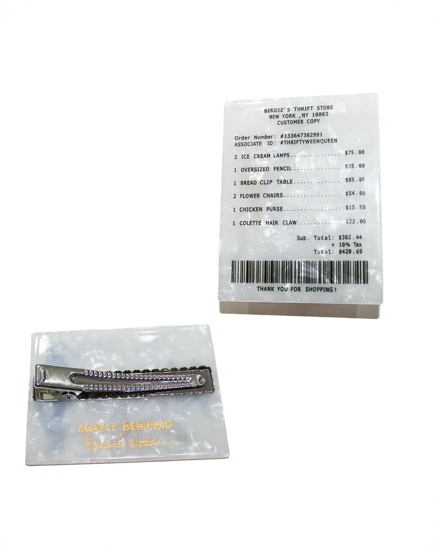 front and back view of birdie wood store receipt hair clip