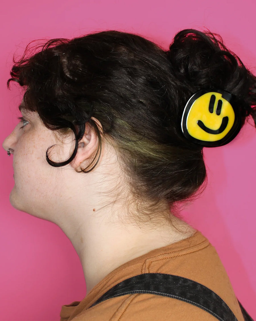 model wearing birdie wood collab yellow smiley hair claw