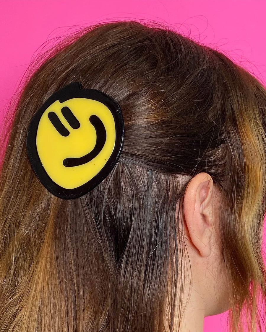 model wearing birdie wood collab yellow smiley hair clip in their hair