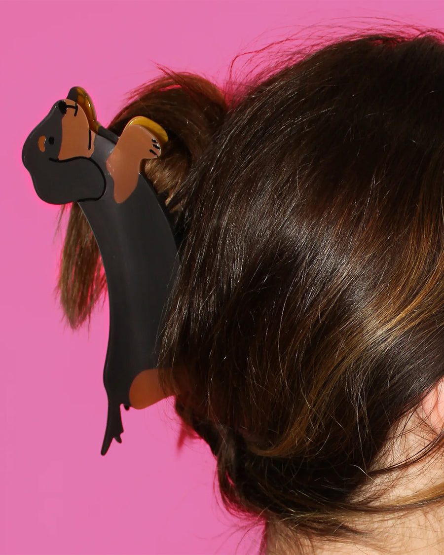 model wearing birdie wood collab black and brown weenie dog hair claw 