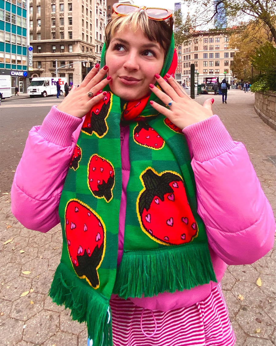 model wearing green plaid scarf with all over strawberry print