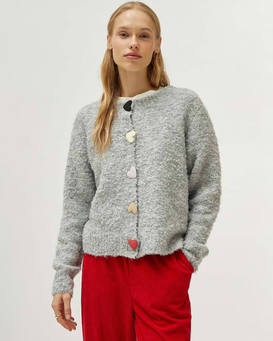 model wearing grey fuzzy cardigan with multicolor heart shaped buttons