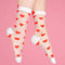 model wearing sheer socks with red heart print and white trim