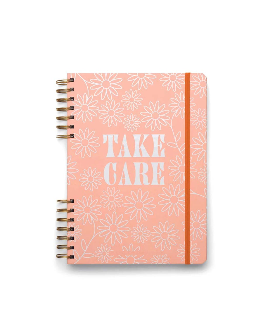 pink guided wellness journal with white flower and 'take care' across the front