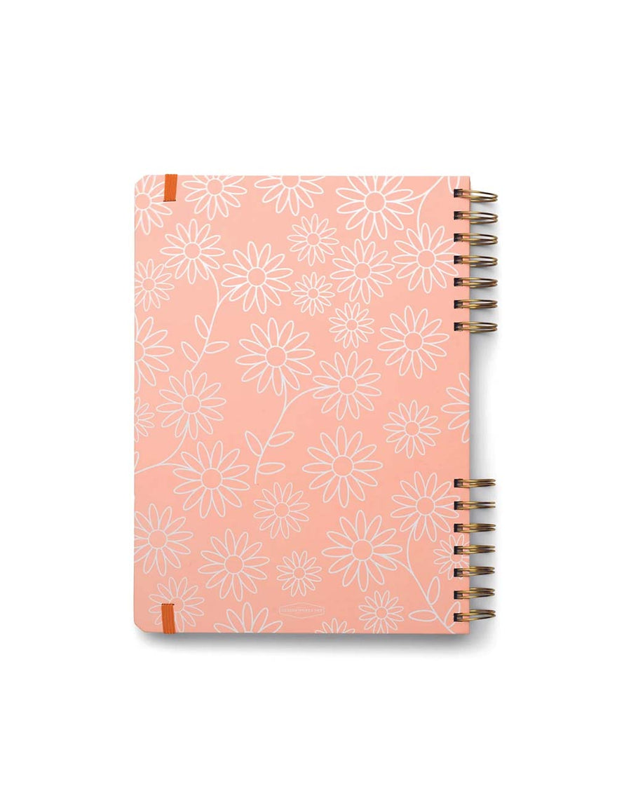 back view of pink guided wellness journal with white flower and 'take care' across the front