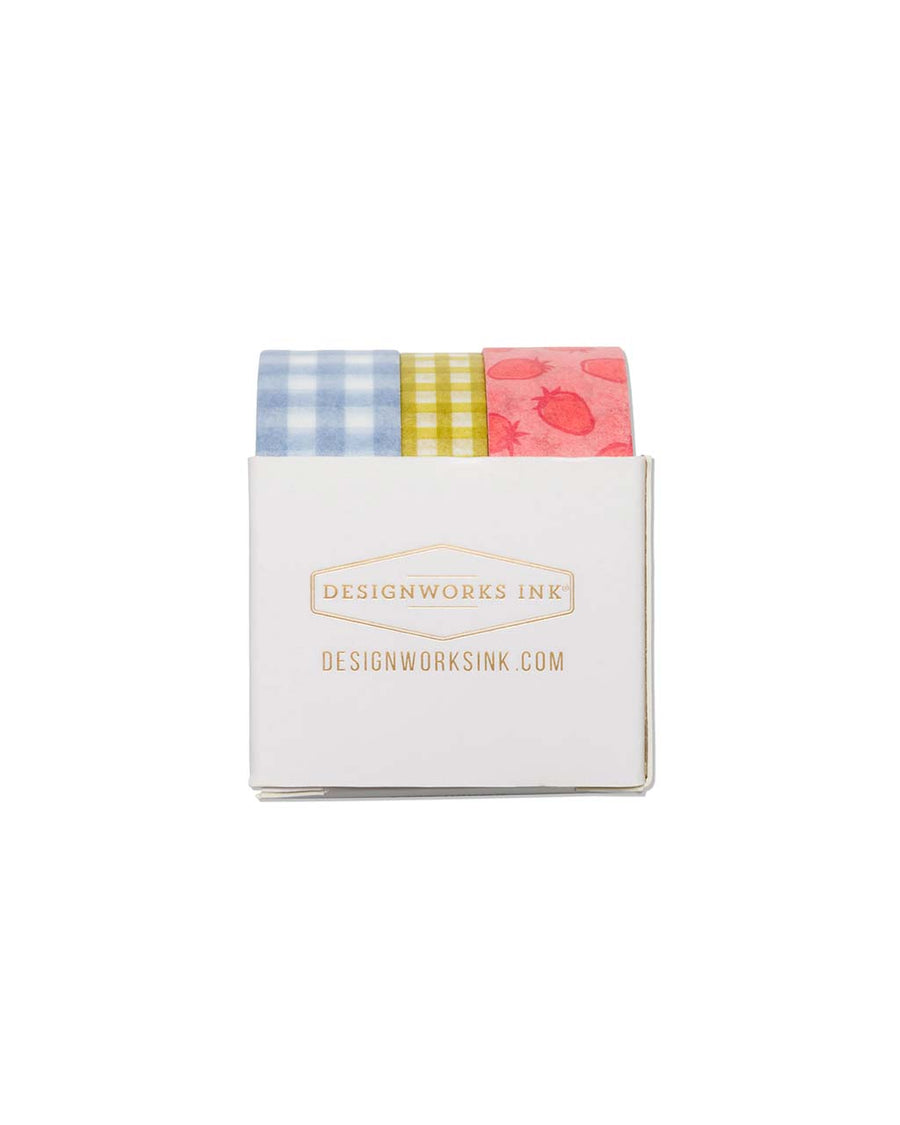 side view of Set of 3 washi tape features a roll of blue gingham, yellow gingham, and strawberry print design.