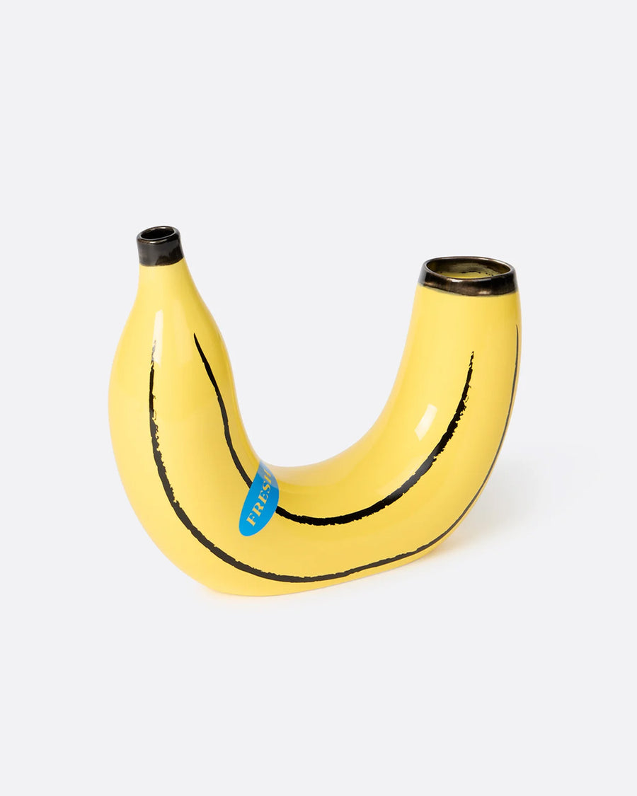 banana shaped vase with flowers on each side