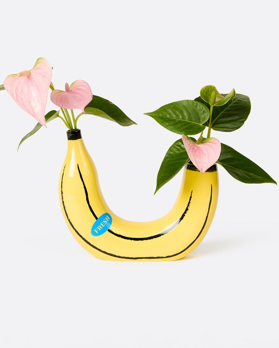 banana shaped vase with flowers on each side