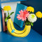 banana shaped vase with flowers on each side