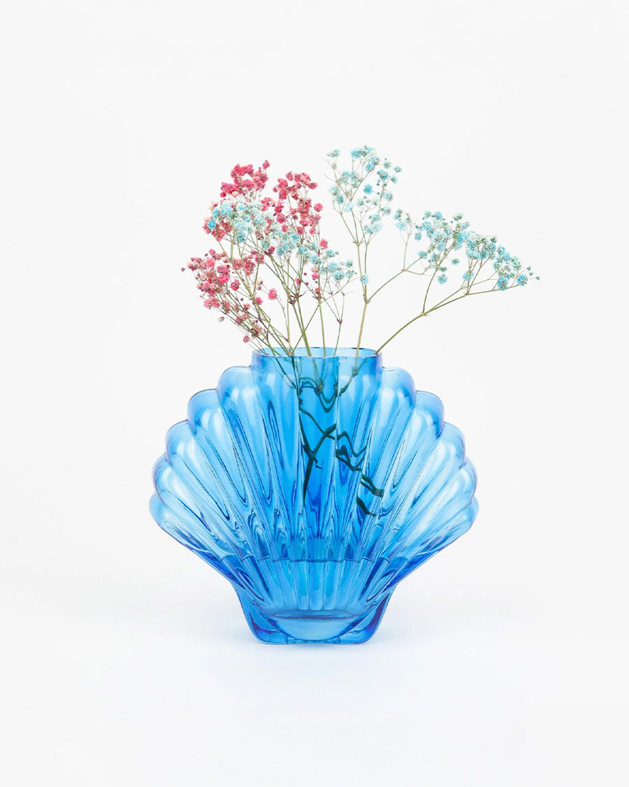 cobalt blue glass seashell vase with dainty flowers inside