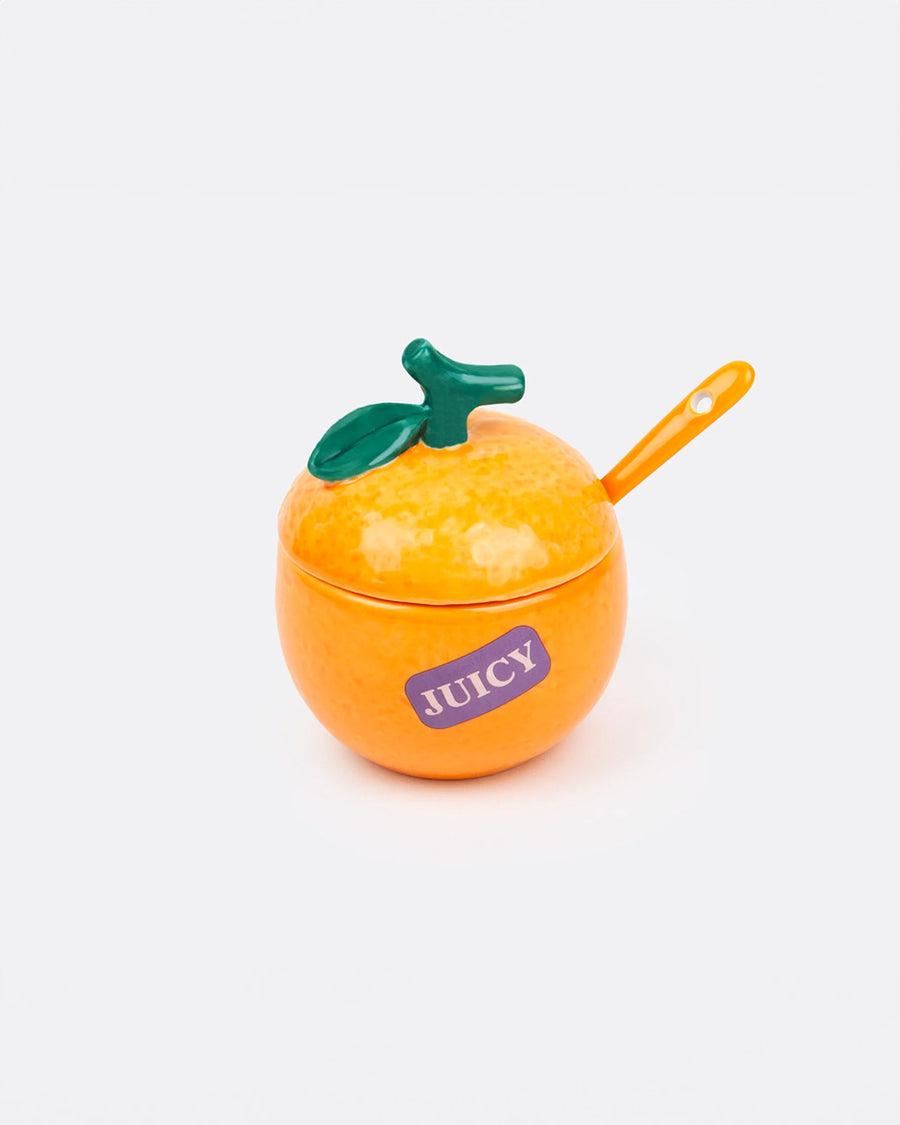 orange ceramic sugar bowl with purple 'juicy' sticker on the side