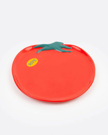 tomato shaped plate with yellow 'ripe' sticker on the left side