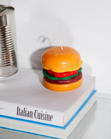 burger shaped candle on a stack of books