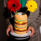 model holding cheeseburger shaped vase on a tray