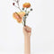 hand vase with flowers sticking out of the hands