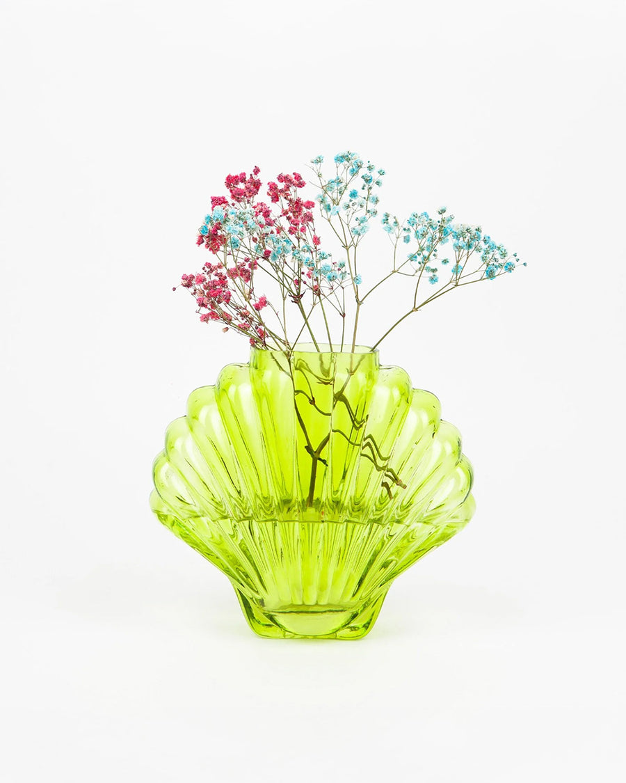 lime green glass seashell vase with dainty flowers inside