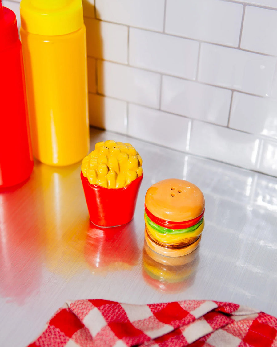 burger and fries shaped salt and pepper shakers on a table