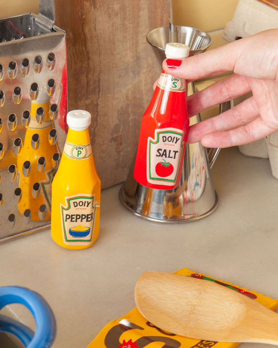 model using yellow mustard and red ketchup shaped salt and pepper shakers