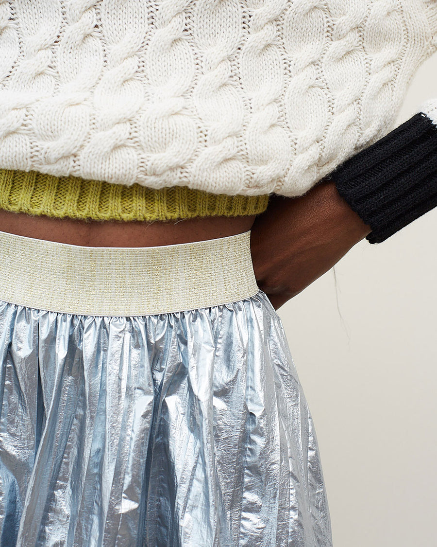 up close of model wearing silver midi skirt with vertical stripe detail