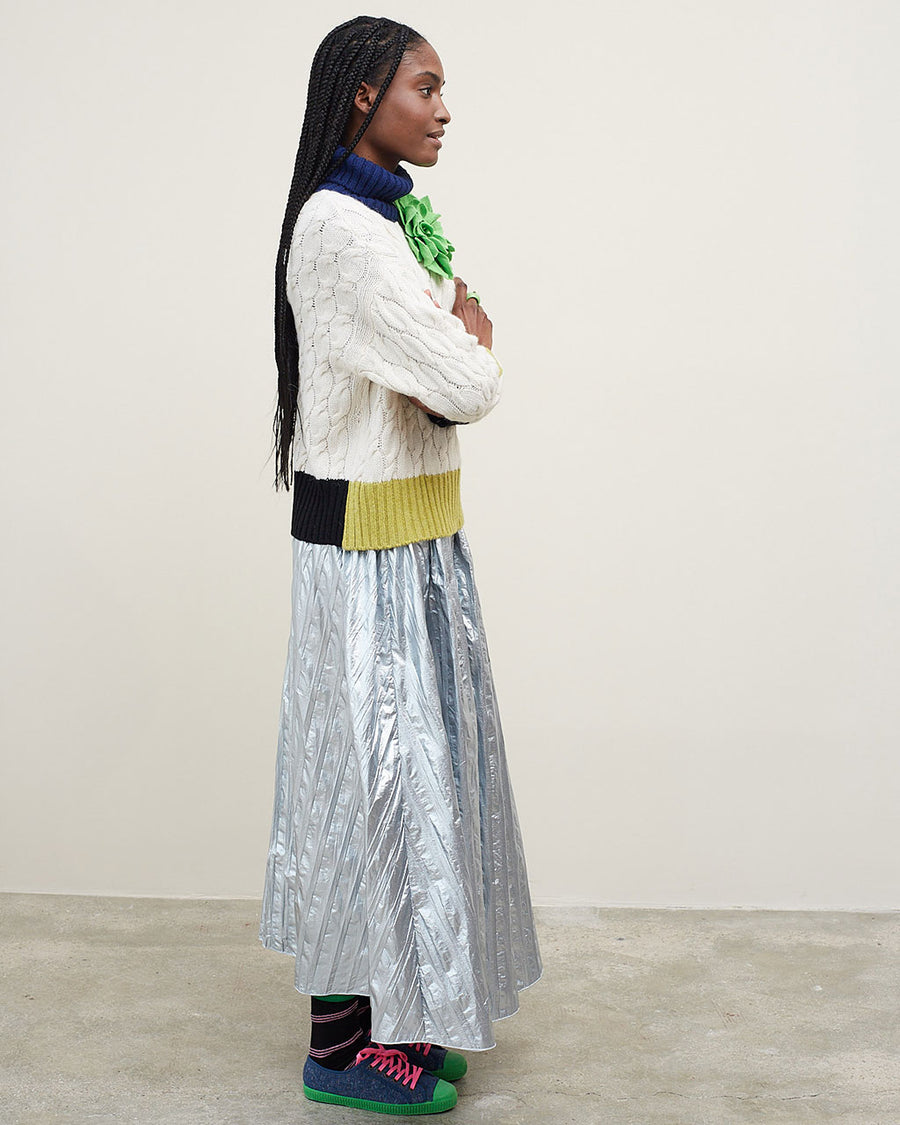 side view of model wearing silver midi skirt with vertical stripe detail